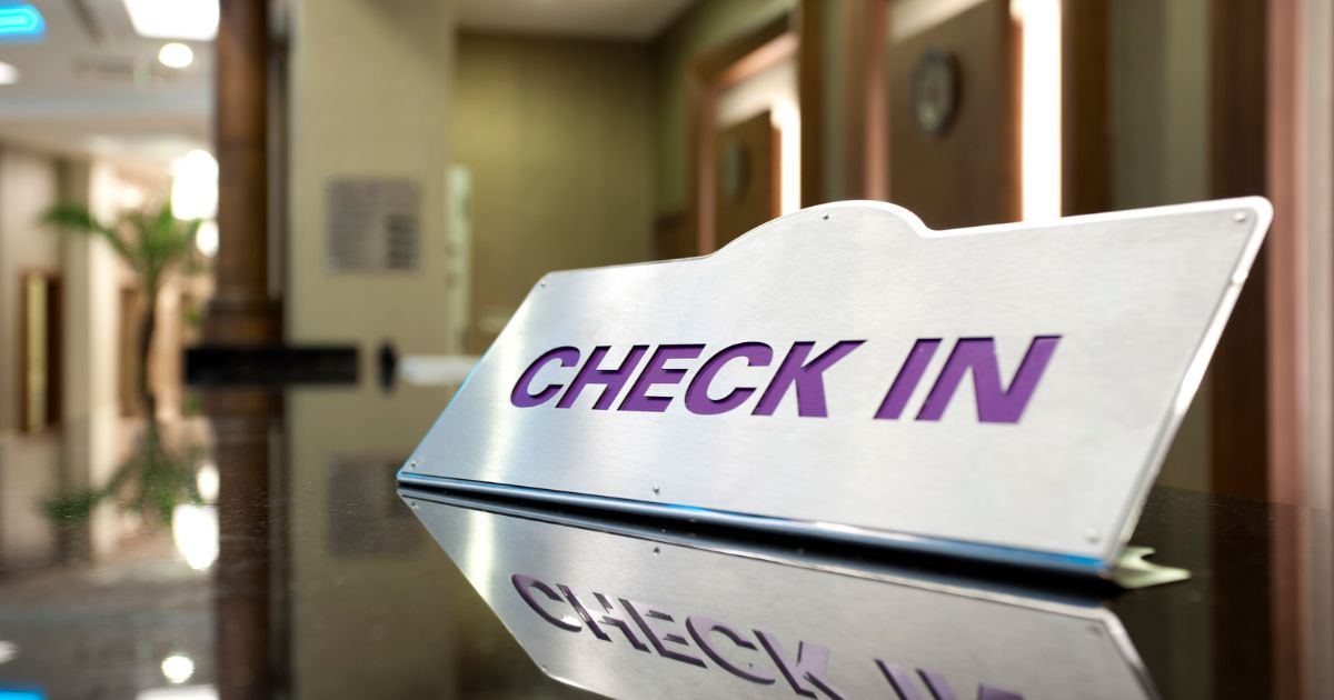close up shot of a check in sign at a hotel