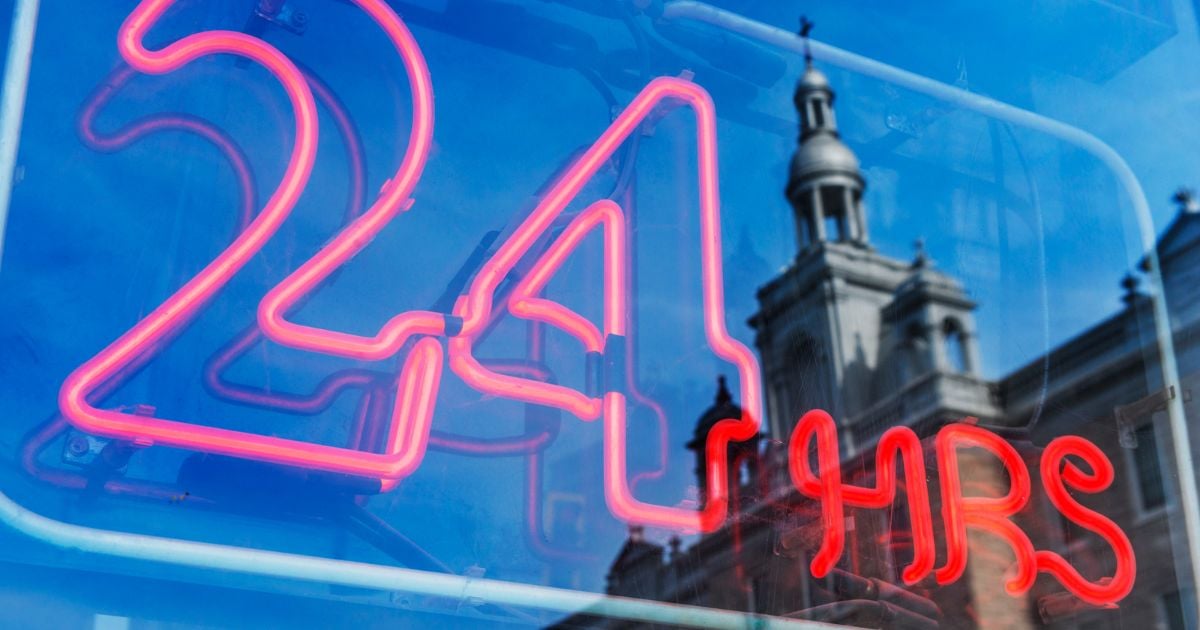 bright red neon 24 hour hotel check in sign